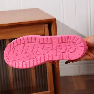 Detail view of the durable pink anti-slip sole on warm fuzzy winter loafer shoes.