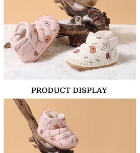 Detailed display of warm baby snow boots with cute cartoon bear prints in winter setting