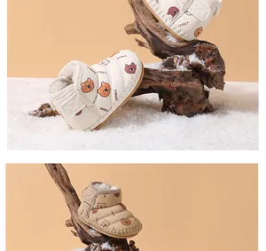 Close-up of warm fleece-lined baby winter boots with cute cartoon bear patterns
