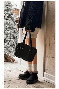 Close-up of black women's ultra-short snow boots with ethnic embroidery and thick platform soles