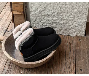Detailed view of black women's snow boots with ethnic embroidery and plush fur lining