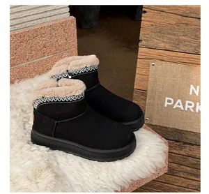 Detailed view of black platform snow boots featuring ethnic embroidery and warm fur lining.