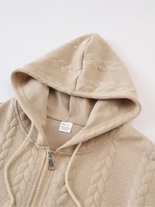 Detailed close-up view of beige quilted zip-up hoodie collar and interior material tag