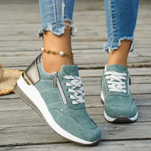 Outdoor lifestyle view of turquoise women's platform sneakers with side zipper