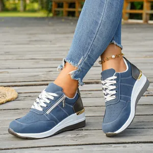 Stylish women's blue wedge platform sneakers featuring side zipper and perforated detail