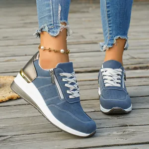Blue wedge sneakers for women featuring metallic gold accents and a side zipper detail