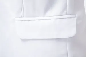 Detailed macro view of the pocket flap and twill fabric on a white slim fit suit jacket