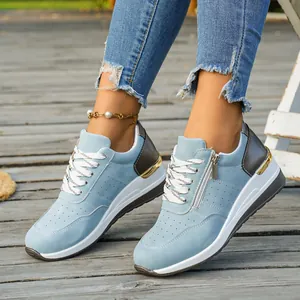 Detailed macro view of light blue women's fashion sneakers with side zipper closure