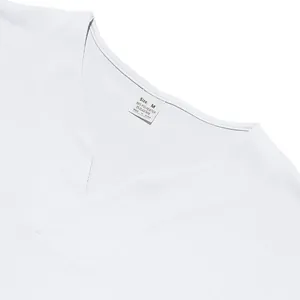 Detailed close-up of white V-neck T-shirt neckline showing fabric texture and care label