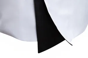 Macro view of high-quality suit fabric and contrast lapel detail on men's slim fit tuxedo jacket