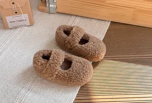 Vista dettagliata di scarpe per bambini in pile sherpa marrone in un ambiente accogliente
