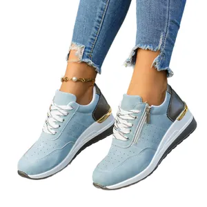 Light blue women's casual sneakers with side zipper and thick sole design.