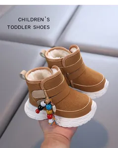 Close-up of brown children's toddler boots with warm fleece lining and colorful beads
