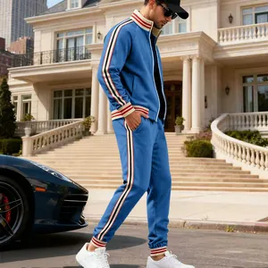 Detailed side view of men's blue heavyweight fleece tracksuit with striped side bands