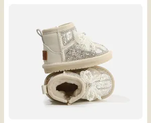 Detailed view of girls' white snow boots with pearl bow and warm faux fur lining