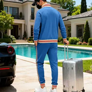 Back view of men's blue heavy fleece tracksuit with red and white stripes
