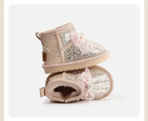 Side and interior detail of pink girls' bow snow boots with pearls and fur lining