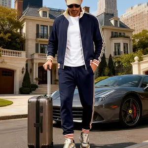 Men's navy blue fleece tracksuit set with striped details in luxury outdoor setting