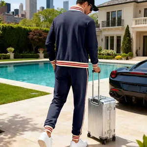 Detailed back view of a man wearing a navy blue heavyweight fleece tracksuit by a pool