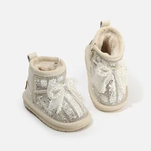 Toddler girls cream glitter snow boots featuring pearl bow detail and warm fleece lining