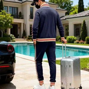 Back view of men's navy blue heavyweight fleece tracksuit with red striped trim detail