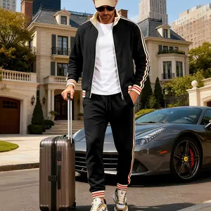 Detailed view of men's black fleece tracksuit set with striped accents in lifestyle setting
