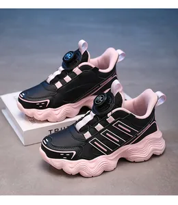 Close-up detail of kids' waterproof sneakers with rotary buckle in black and pink