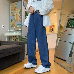 Detail view of men's loose straight-leg blue denim jeans for casual everyday wear