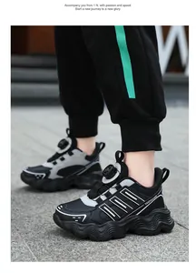 Detailed side view of children's black sneakers with a convenient rotary dial closure