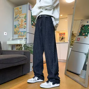 Comfortable men's loose fit straight leg dark gray jeans in a casual domestic setting