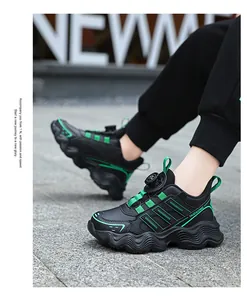 Detail view of kids' black waterproof sports sneakers with green accents and rotary buckle
