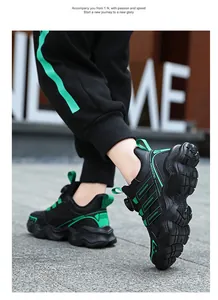 Detail view of black and green kids' sneakers with a rotating dial closure system.