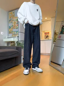 Men's casual loose straight-leg dark jeans shown in a lifestyle indoor setting