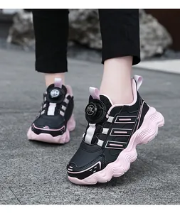 Detailed view of pink and black children's chunky sneakers with rotary buckle system