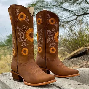 Detailed view of brown leather western boots featuring elegant sunflower embroidery.