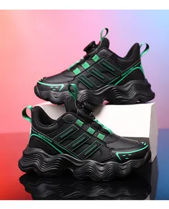 Close-up detail of black children's sports sneaker with rotating buckle and green trim