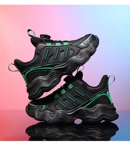 Black and green chunky kids' sneakers featuring a rotating buckle and waterproof leather surface.