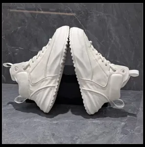 Vista laterale di sneakers alte in pelle off-white con una spessa suola a piattaforma