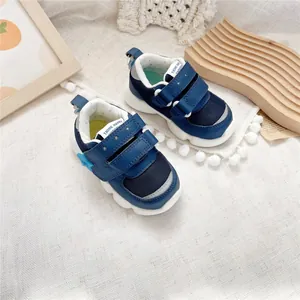 Close-up detail of blue breathable functional baby walking shoes with velcro straps