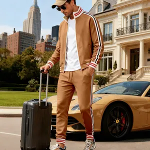 Close-up detail view of men's tan fleece tracksuit set with athletic side stripes