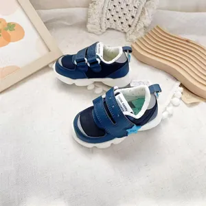Detail of navy blue toddler walking shoes with mesh upper and hook-and-loop straps.