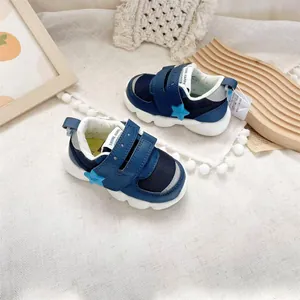 Navy blue lightweight baby functional shoes with star detail and velcro closures.