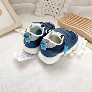 Close-up of navy blue baby walking shoes with star details and velcro straps