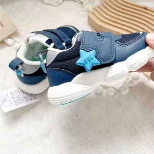 Blue functional toddler walking shoes with mesh upper and star-shaped velcro strap