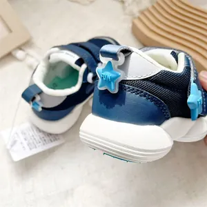 Close-up view of navy blue baby walking shoes featuring a decorative blue star FUN detail
