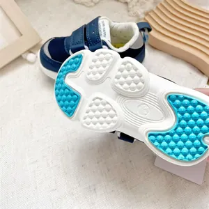 Macro view of the durable anti-slip blue and white sole of toddler functional walking shoes