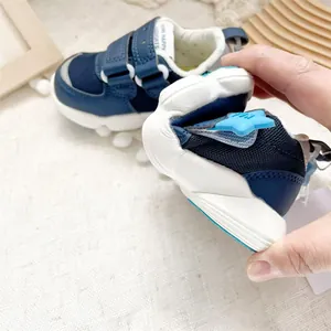 Detail showing flexibility of navy blue toddler walking shoe with Velcro straps
