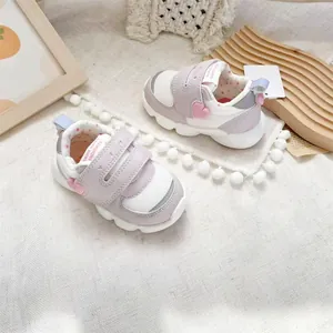 Lavender and white breathable mesh baby walking shoes with heart detail and magic straps.
