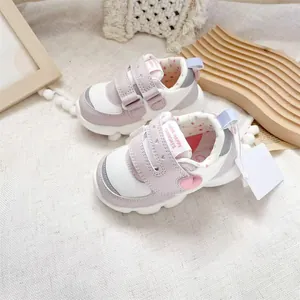 Detailed view of lavender baby walking shoes with heart accent and Velcro straps