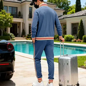 A detailed back view of the men's blue heavy fleece tracksuit with red stripe accents.